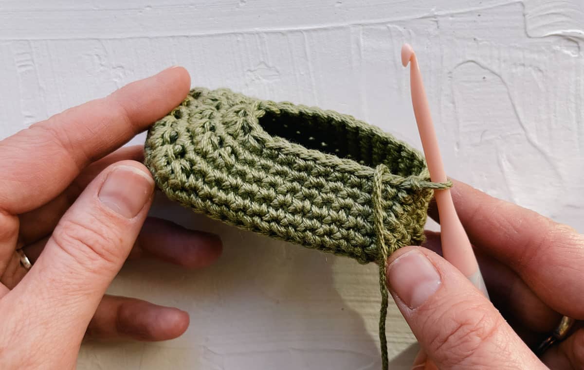 Infant crochet shoe in progress, before ribbing is added.