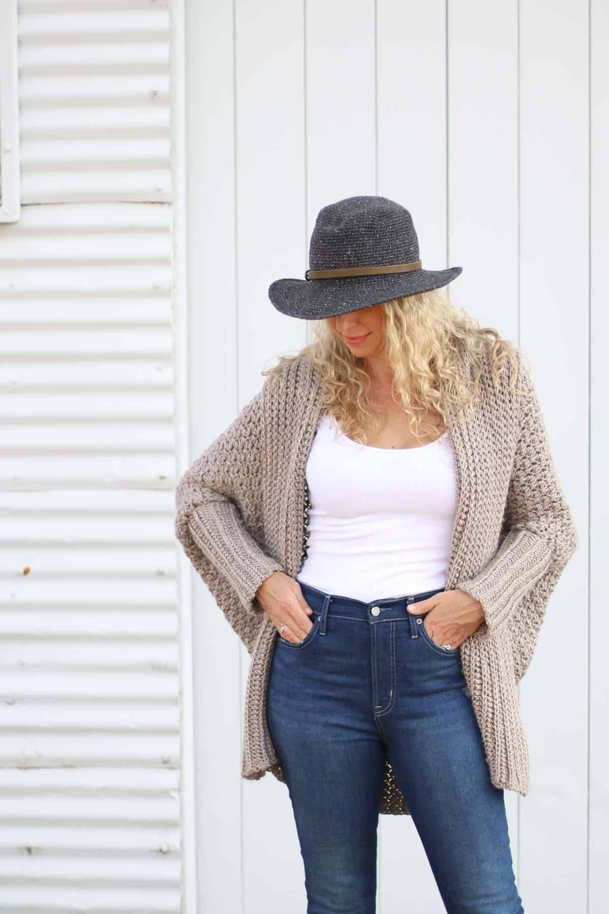 A blonde woman wearing an oversized, baggy modern crochet cardigan. This free crochet cardigan pattern is very easy thanks to the sweater being crocheted from a simple rectangle. 