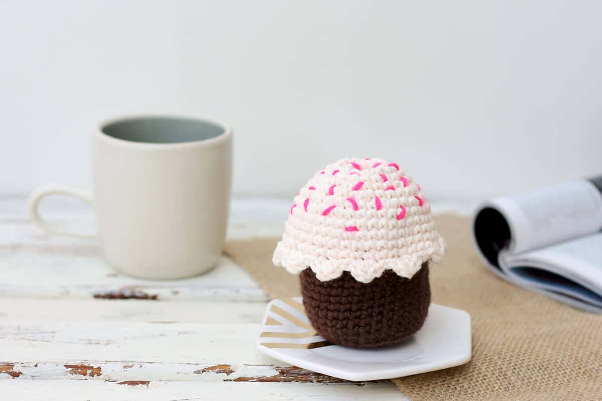 This free amigurumi crochet cupcake pattern makes a perfect DIY gift idea for a toddler or child. The birthday candle adds even more possibilities for play to this sweet toy. Or make it for a friend or co-worker when you need a calorie-free birthday gift! | MakeAndDoCrew.com