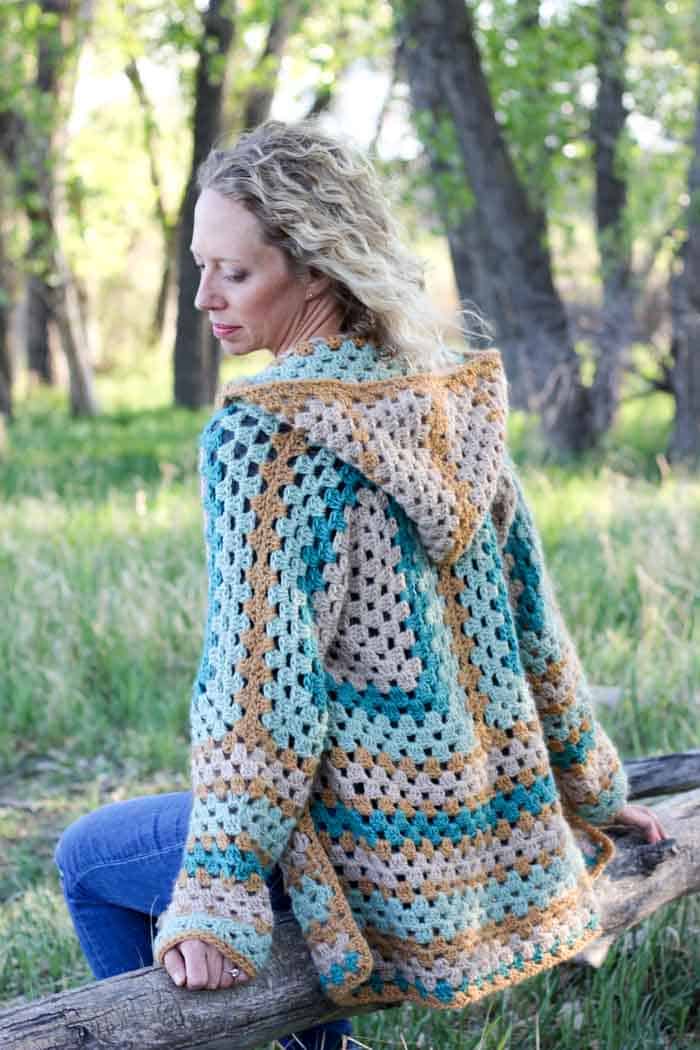 Believe it or not, two simple granny hexagons are the foundation of this free crochet hexagon sweater pattern. "The Campfire Cardigan" is made with Lion Brand New Basic 175 in Juniper, Cafe Au Lait, Thyme and Camel. Easily make this modern boho crochet sweater pattern!