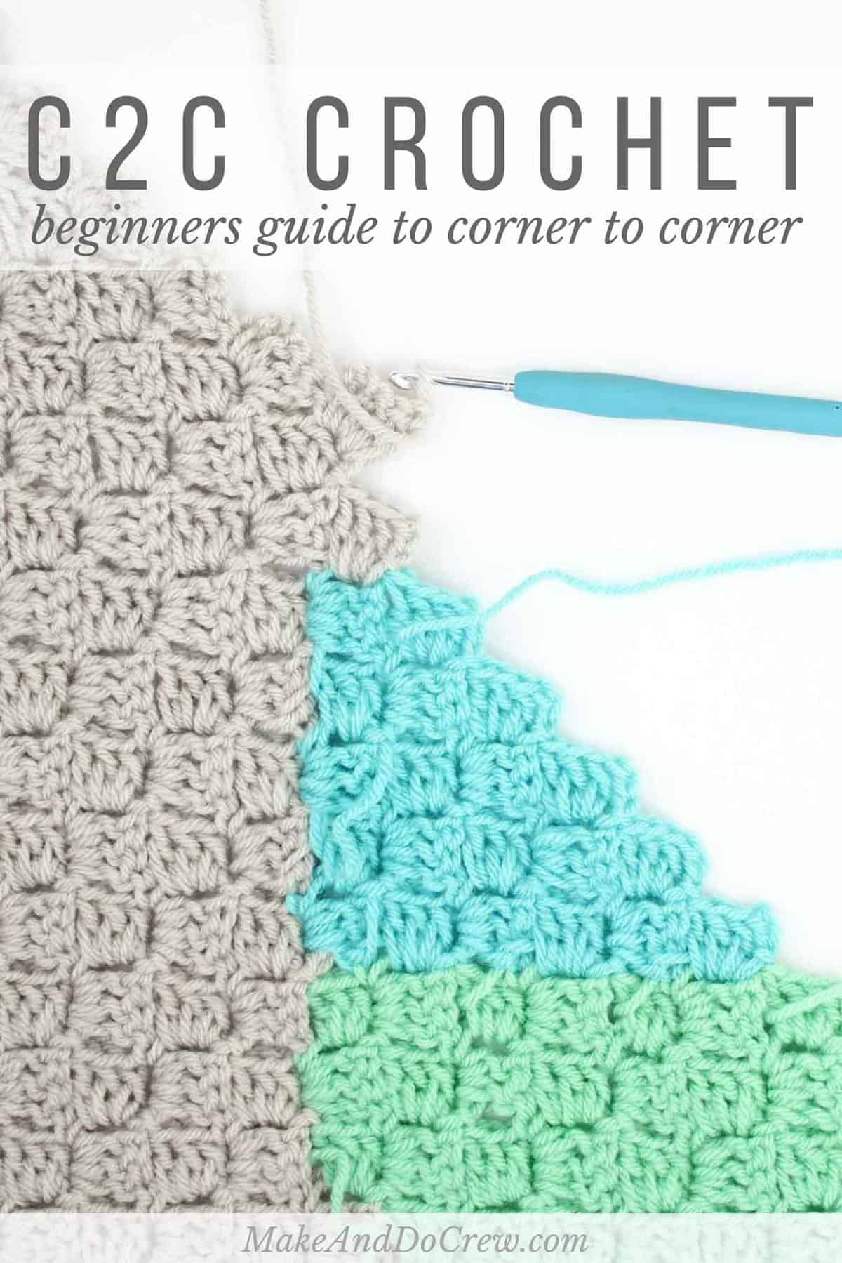 A close-up shot of a gray, teal, and green-colored corner-to-corner crochet blanket and a crochet hook on a white background.