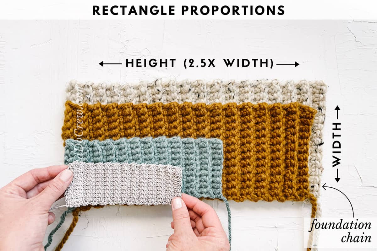 A series of four crochet rectangles made of scrap yarn in different sizes stacked on top of each other. A woman's hands are reaching into the frame to grab one rectangle.