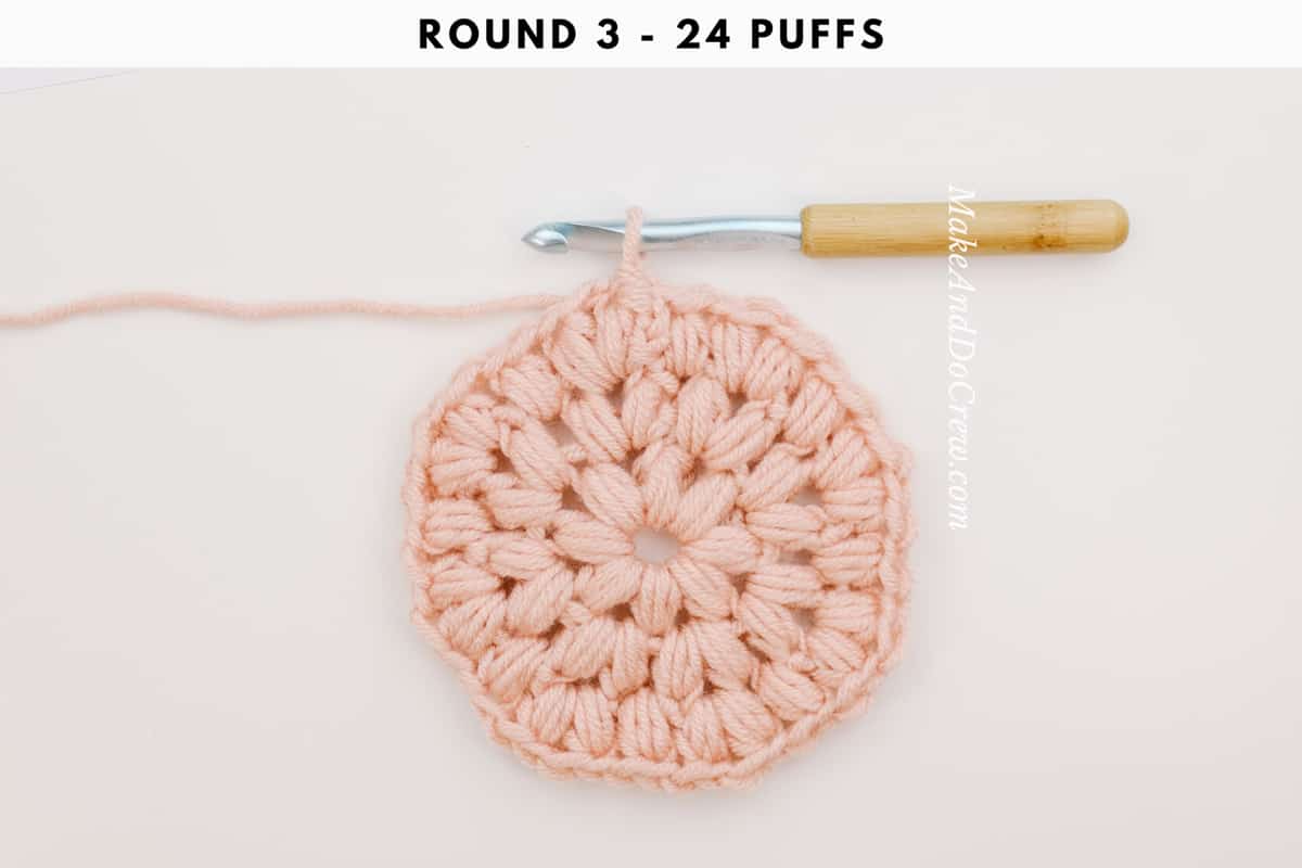 Round 3 of a crochet puff stitch circle.
